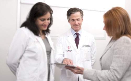 Dr. Saunders talking with his staff